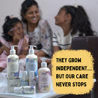 Avee Kids care products on a table with a family in the background and a motivational quote.